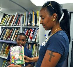 Natacha Maldonado showcases one of her son Armani Doward&rsquo;s favorite series of books &ndash; Captain Underpants &ndash; inside St. Croix&rsquo;s Public Library Bookmobile Saturday. 